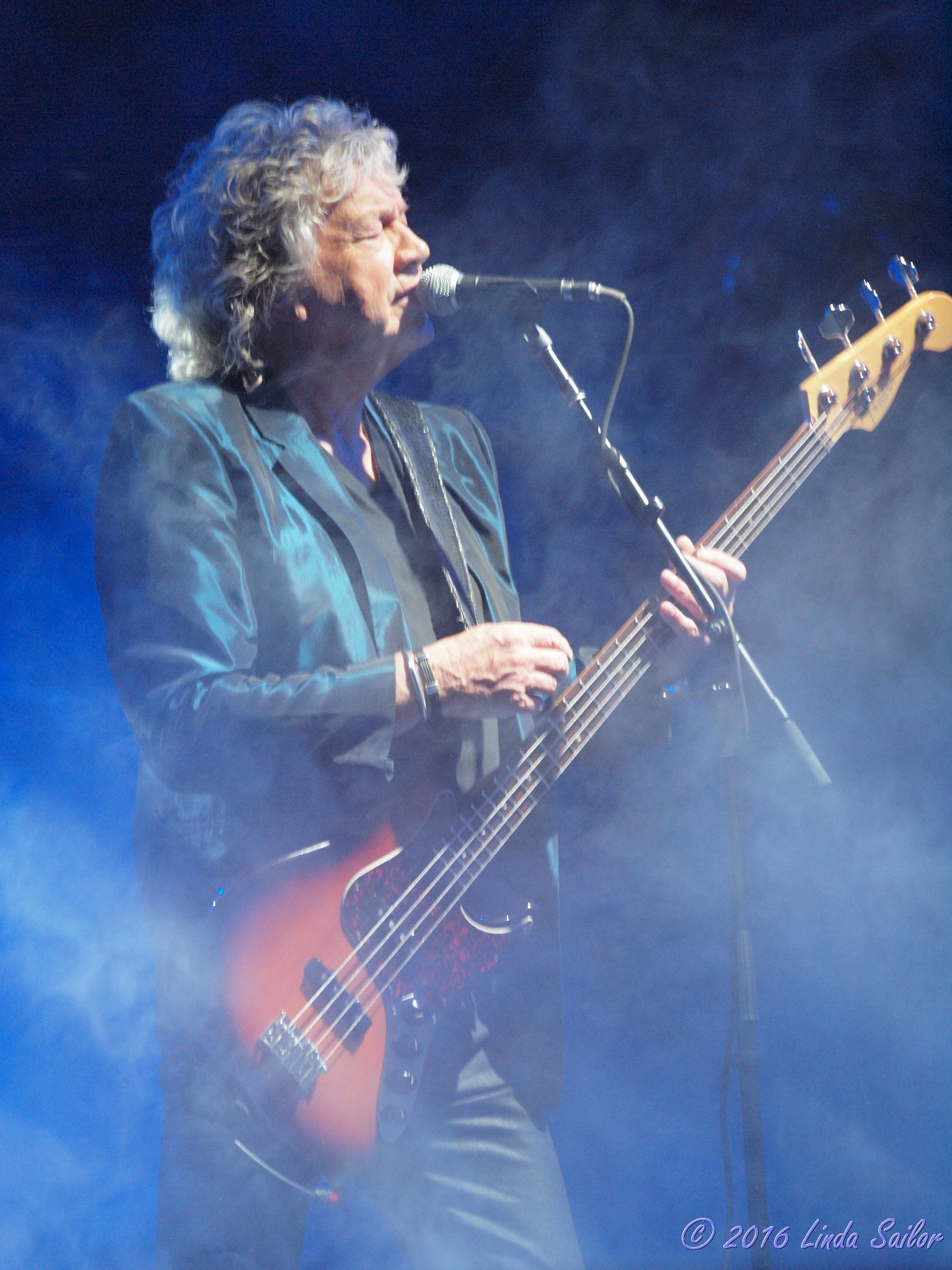 John Lodge performing under blue concert lighting
